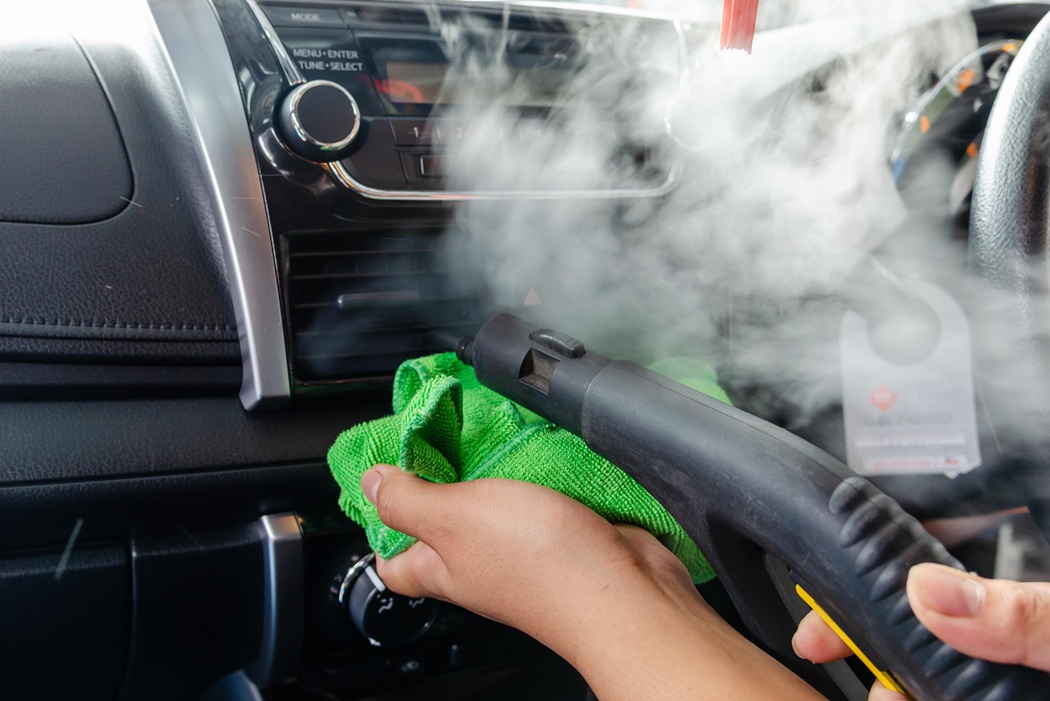 Morris County NJ technician steam cleaning a car interior for deep sanitizing results