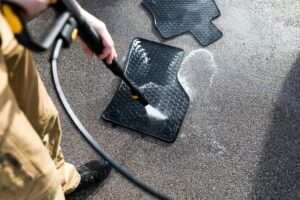 Cab Detailing NJ technician cleaning car floor mats using safe detailing methods - best way to Clean Car Floor Mats